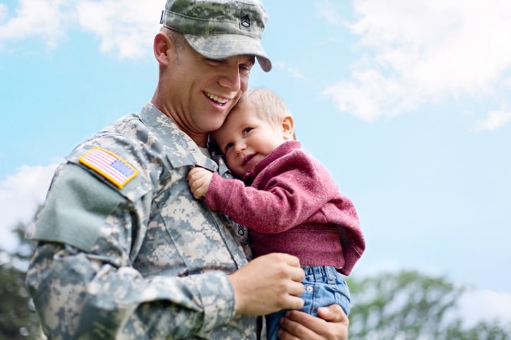 Picture of a uniformed soldier holding a child