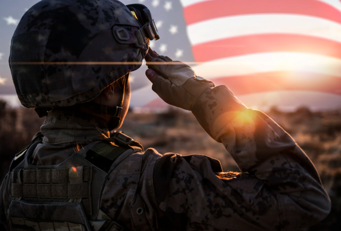 A soldier saluting the American flag at sunrise, displaying patriotism and respect for the USA.